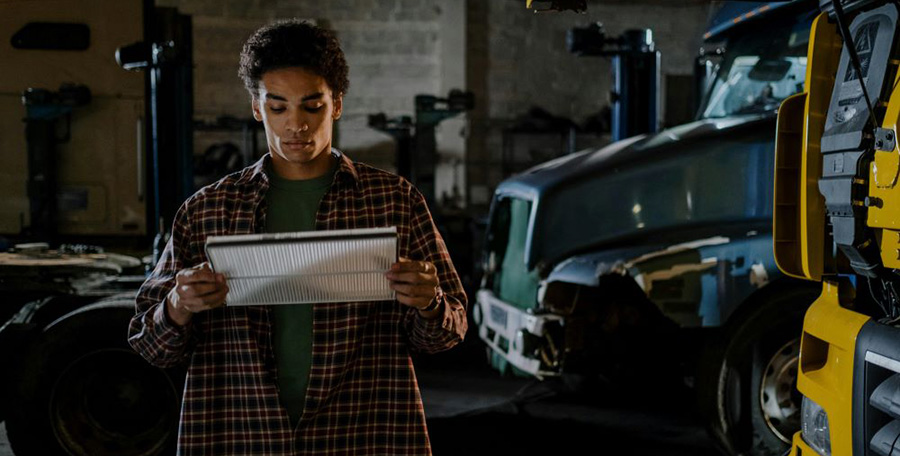 An auto-mechanic looking at an air filter avoiding common brake maintenance mistakes